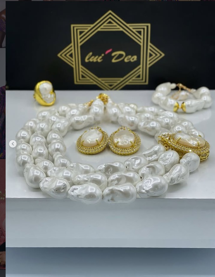 A baroque pearl set with gold cabochon